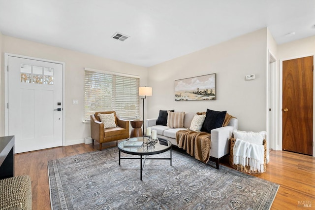 living room with wood finished floors and visible vents