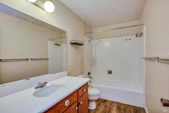 full bathroom with hardwood / wood-style floors, vanity, toilet, and shower / bathtub combination