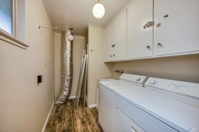 clothes washing area featuring dark hardwood / wood-style flooring, cabinets, and washing machine and clothes dryer