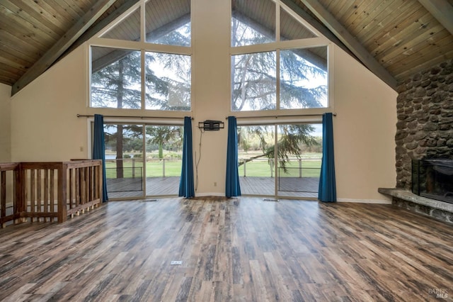 unfurnished living room with a wealth of natural light, a fireplace, high vaulted ceiling, and hardwood / wood-style flooring