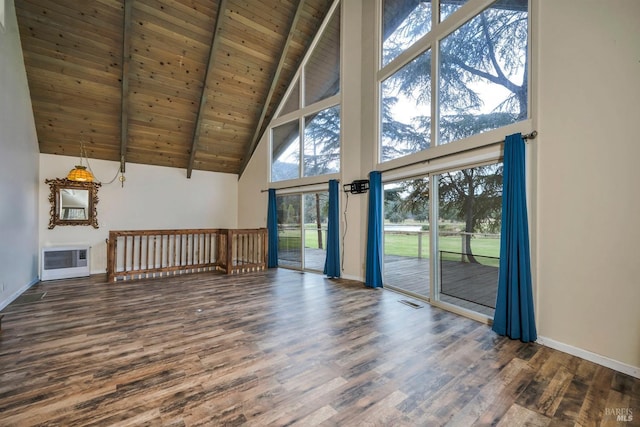 unfurnished living room with heating unit, wood finished floors, baseboards, wood ceiling, and beamed ceiling