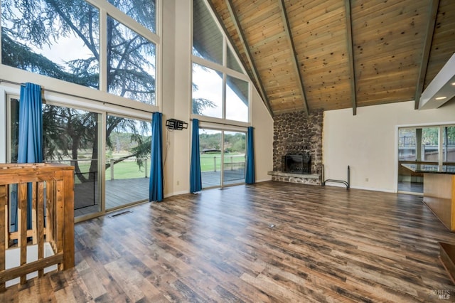 unfurnished living room featuring dark wood-type flooring, high vaulted ceiling, a fireplace, beamed ceiling, and wood ceiling