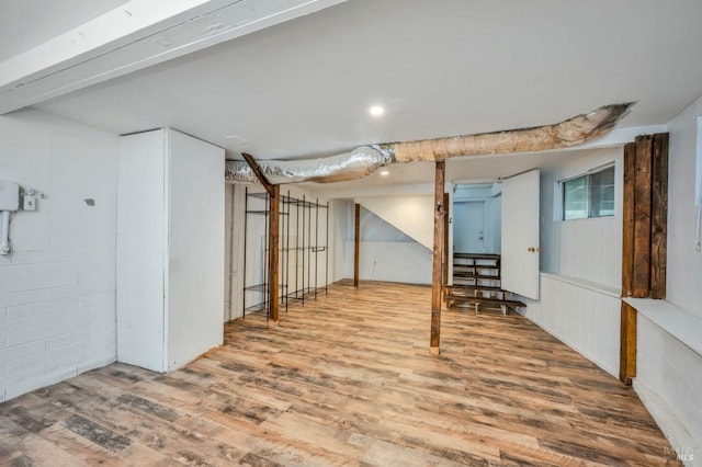 basement with hardwood / wood-style flooring