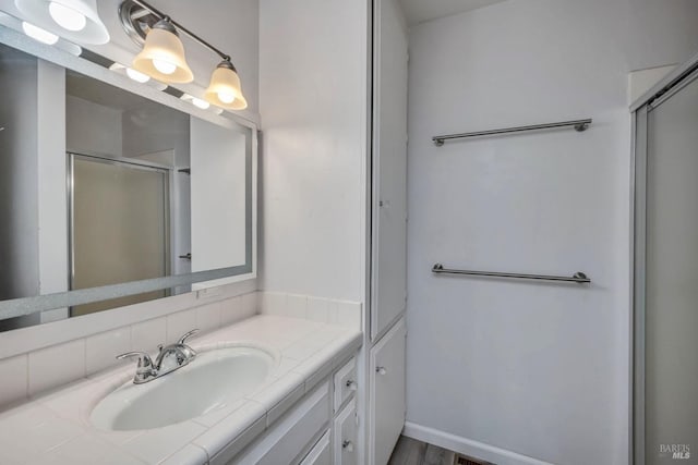 bathroom with a shower with door, vanity, and wood-type flooring