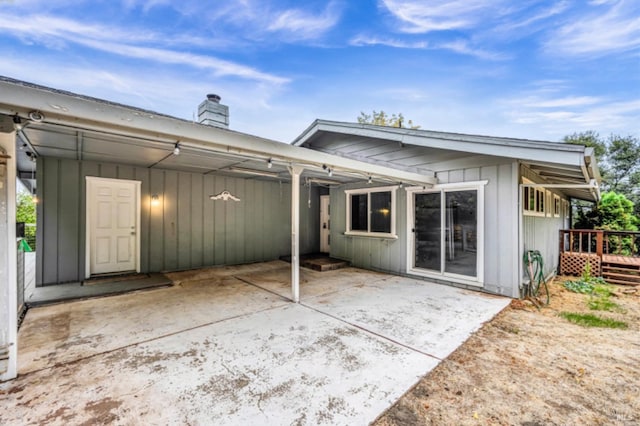 rear view of house with a patio area and a wooden deck