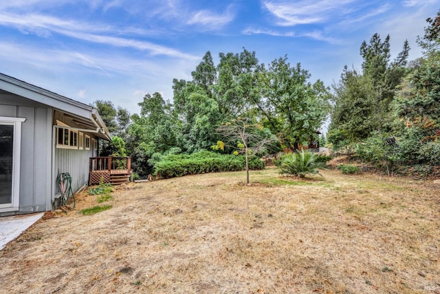 view of yard featuring a wooden deck