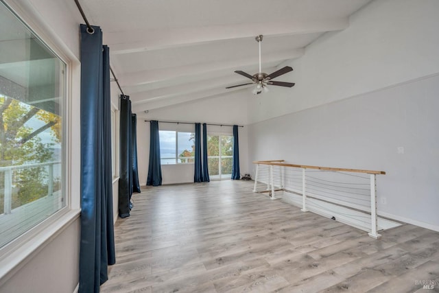 spare room with lofted ceiling with beams, light hardwood / wood-style flooring, and ceiling fan