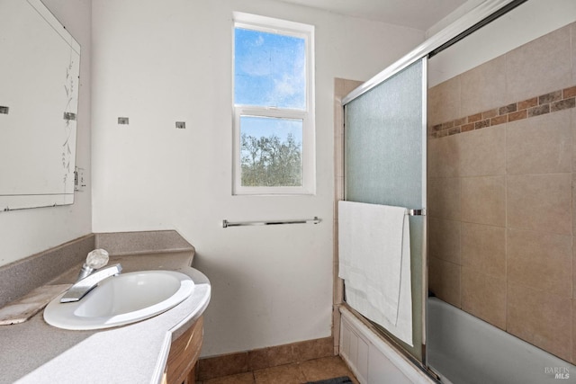 bathroom with tile patterned floors, vanity, and shower / bath combination with glass door