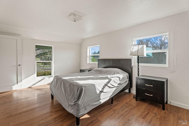 bedroom featuring hardwood / wood-style floors and vaulted ceiling