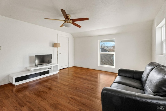 living room featuring a textured ceiling, ceiling fan, vaulted ceiling, and hardwood / wood-style flooring