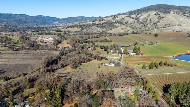 drone / aerial view featuring a rural view and a water and mountain view