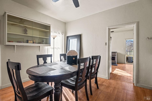 dining room with ceiling fan and wood-type flooring