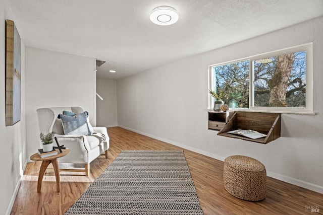 living area with hardwood / wood-style flooring