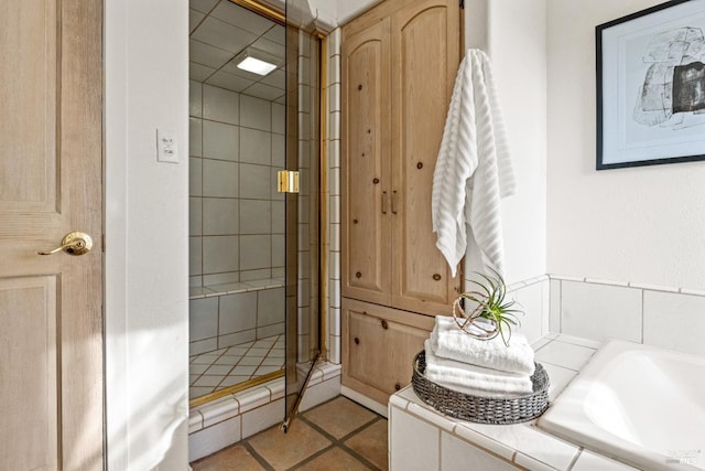 bathroom with tile patterned floors and separate shower and tub