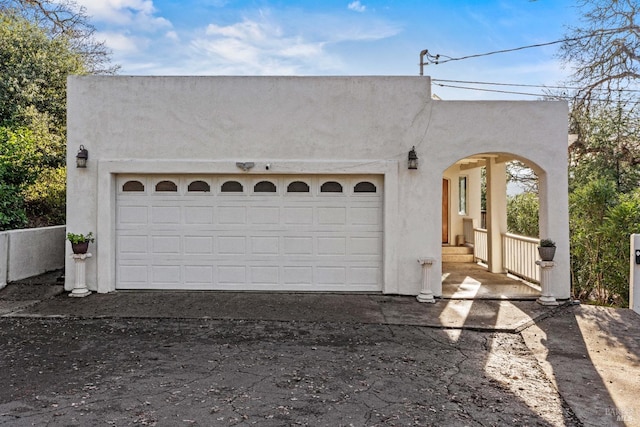 pueblo-style house featuring a garage