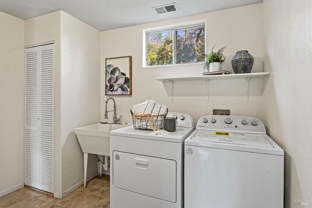 laundry room featuring sink and washing machine and dryer