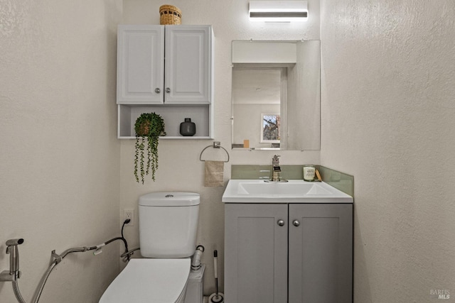 bathroom featuring vanity, an AC wall unit, and toilet