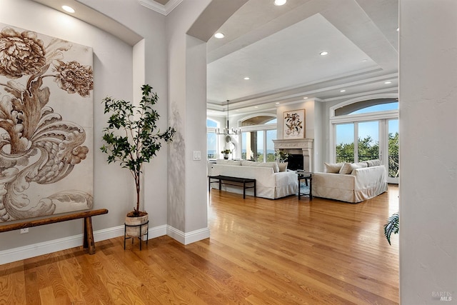 entrance foyer featuring light wood-type flooring and crown molding