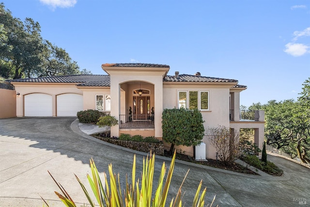 mediterranean / spanish home featuring a garage