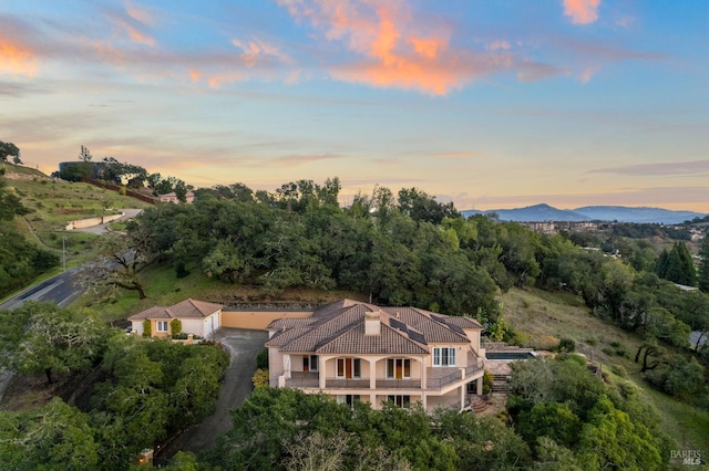 aerial view at dusk featuring a mountain view