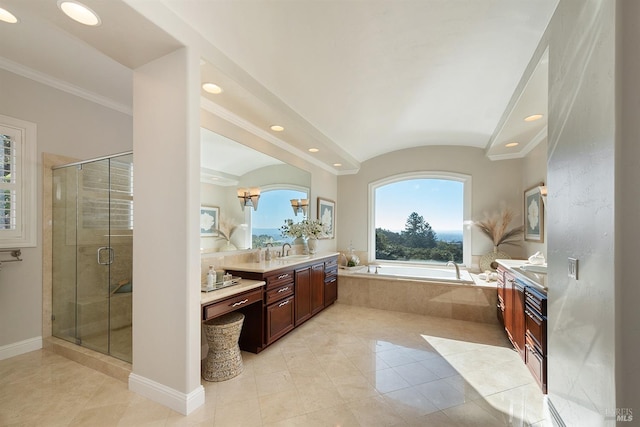 bathroom with tile patterned floors, vanity, ornamental molding, and shower with separate bathtub