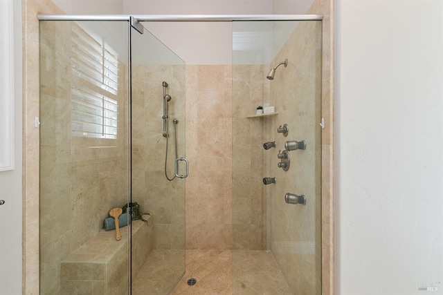 bathroom featuring a shower with door