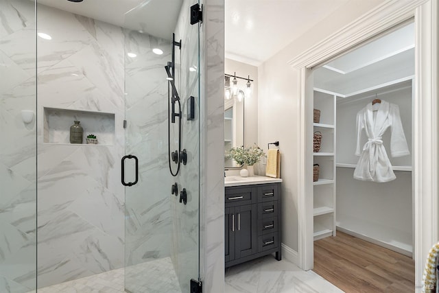 bathroom featuring walk in shower and vanity