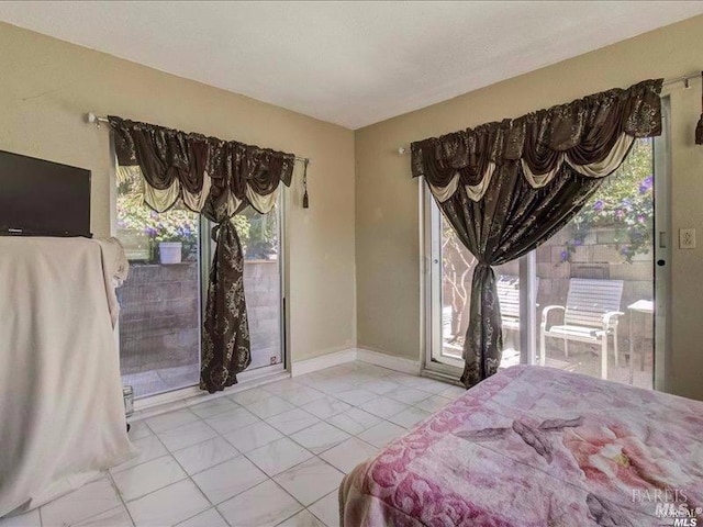 bedroom featuring access to exterior and multiple windows