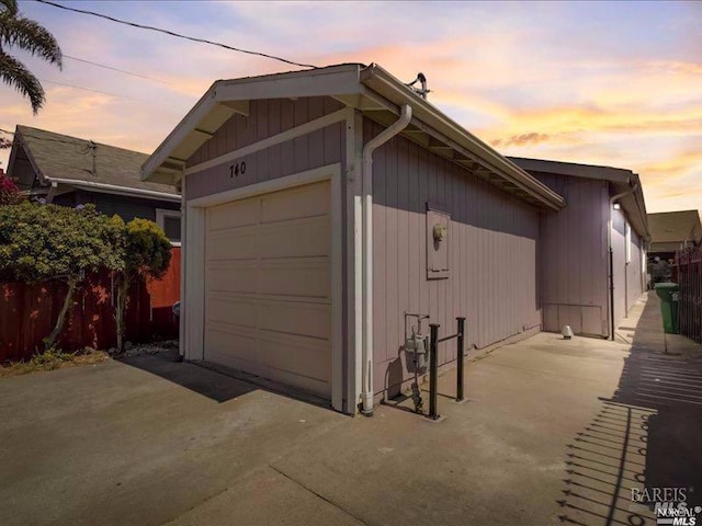 view of garage at dusk