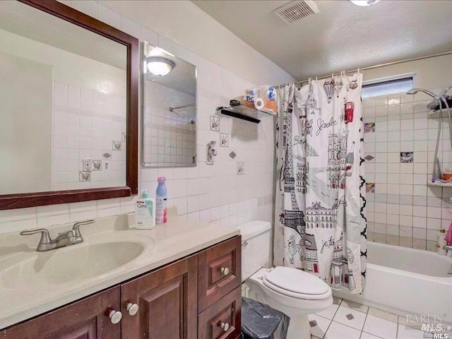 full bathroom featuring tile patterned flooring, decorative backsplash, tile walls, shower / bath combo, and vanity