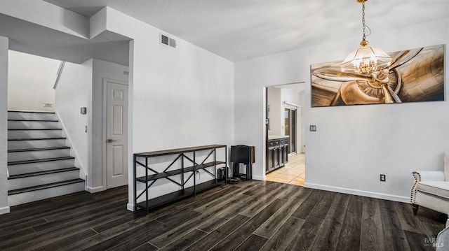 interior space with a chandelier and dark wood-type flooring