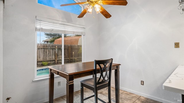 dining room with light tile patterned floors and ceiling fan