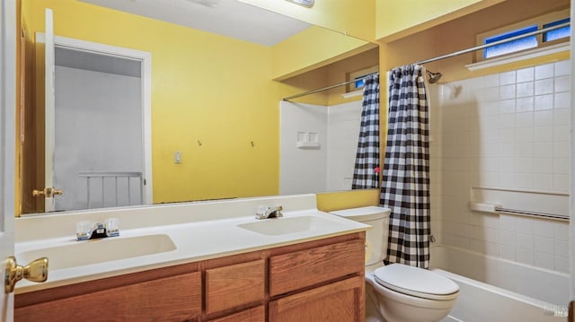 full bathroom featuring vanity, shower / tub combo, and toilet