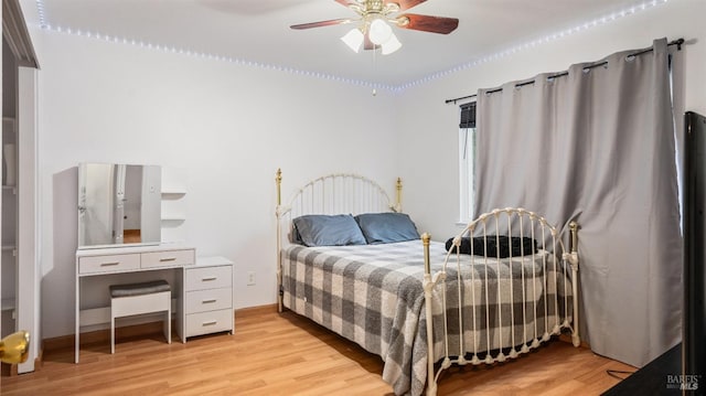 bedroom featuring light hardwood / wood-style floors and ceiling fan