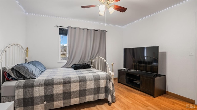 bedroom with hardwood / wood-style flooring and ceiling fan