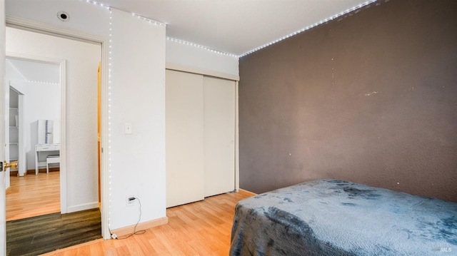 bedroom featuring a closet and light hardwood / wood-style flooring