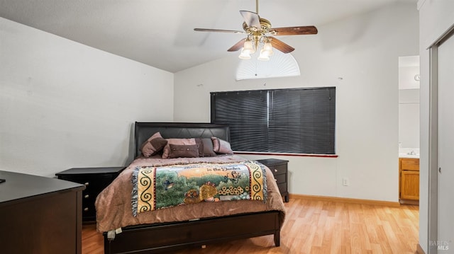 bedroom featuring ensuite bath, ceiling fan, light hardwood / wood-style flooring, and vaulted ceiling