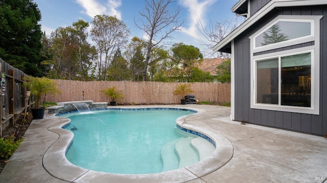 view of pool featuring pool water feature and a patio