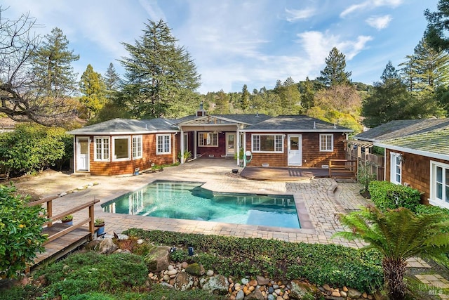 rear view of house with a patio area and a pool side deck