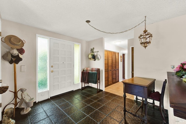 foyer entrance featuring a textured ceiling