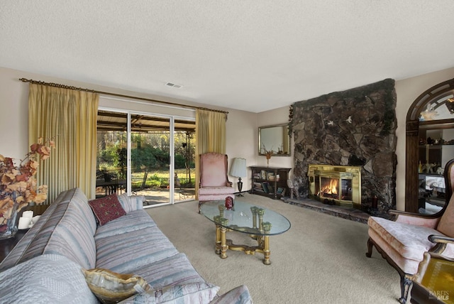 living room featuring carpet flooring, a textured ceiling, and a stone fireplace