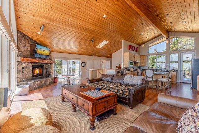 living room with high vaulted ceiling, a fireplace, wood finished floors, wood ceiling, and beam ceiling