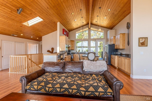 living room featuring wood-type flooring, a skylight, beam ceiling, and wood ceiling