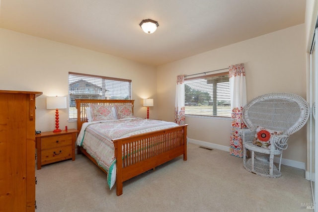 carpeted bedroom with visible vents and baseboards