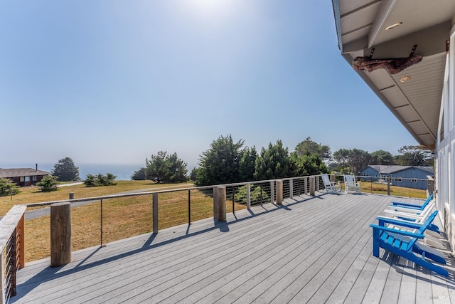 wooden terrace featuring a yard