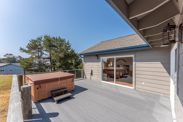 wooden terrace featuring a hot tub