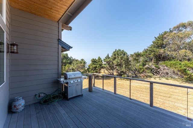 wooden deck featuring a grill