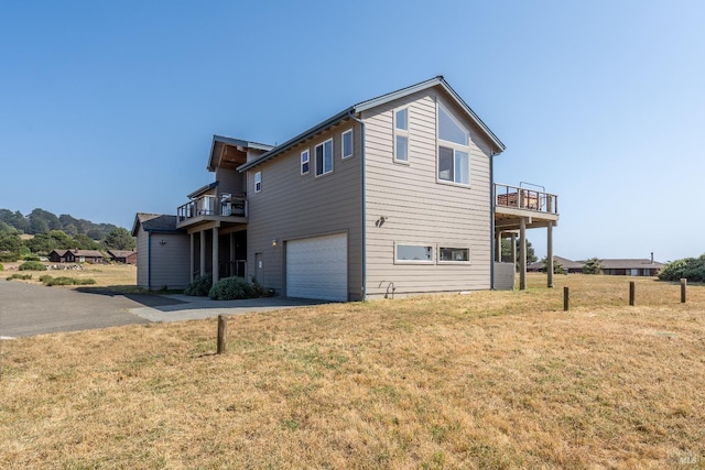 exterior space with driveway, a garage, and a yard