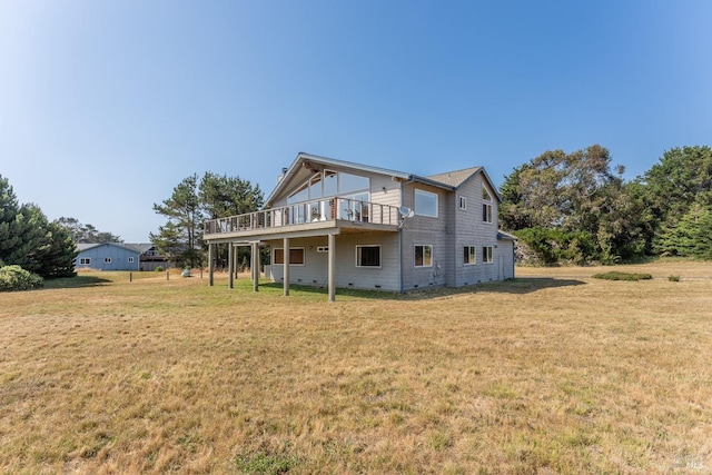 rear view of house with a deck and a lawn