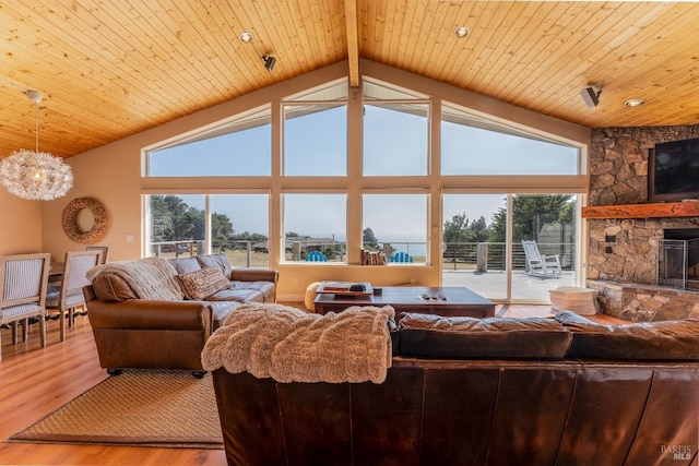 living room featuring high vaulted ceiling, a stone fireplace, light wood-type flooring, and wooden ceiling